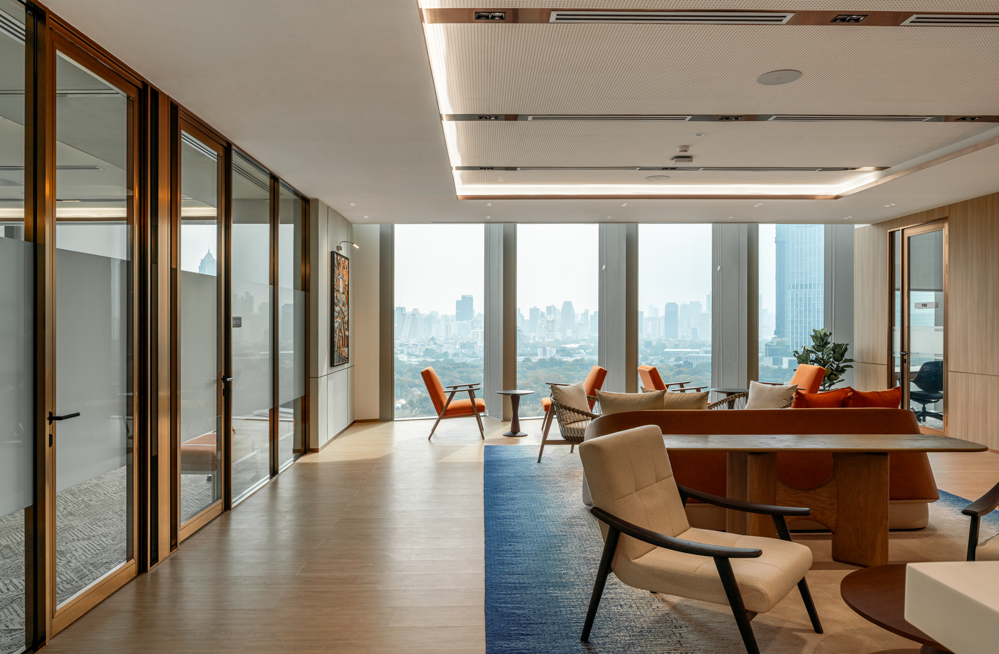 Herbert Smith Freehills Kramer Bangkok office lounge designed by dwp. with city and Lumpini Park views