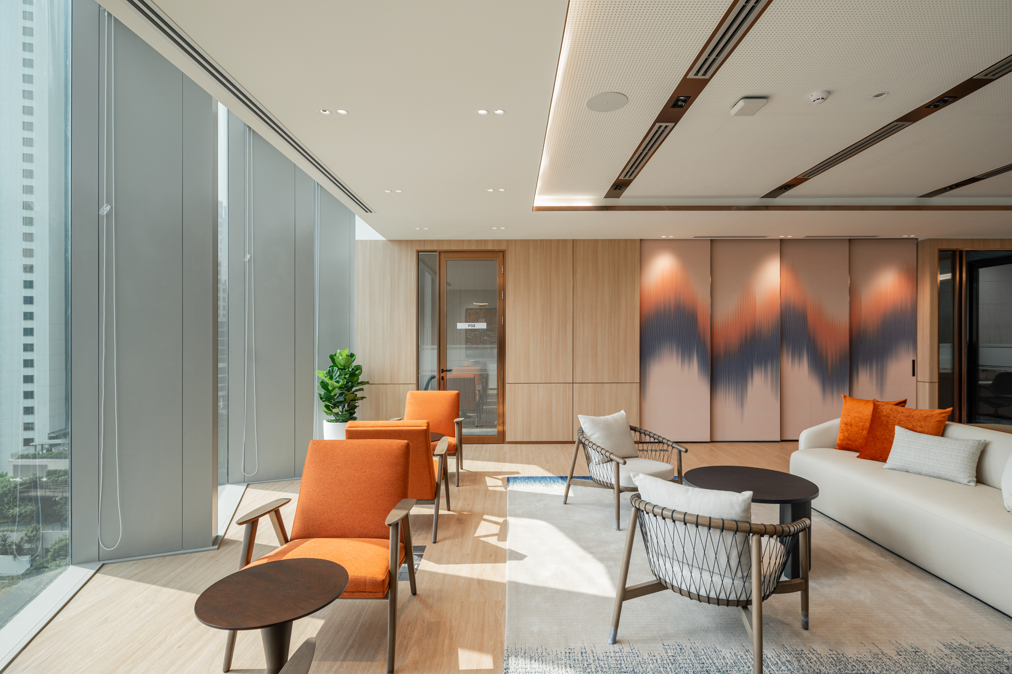 Client lounge at Herbert Smith Freehills Kramer Bangkok office with contemporary furniture and Thai-inspired feature wall