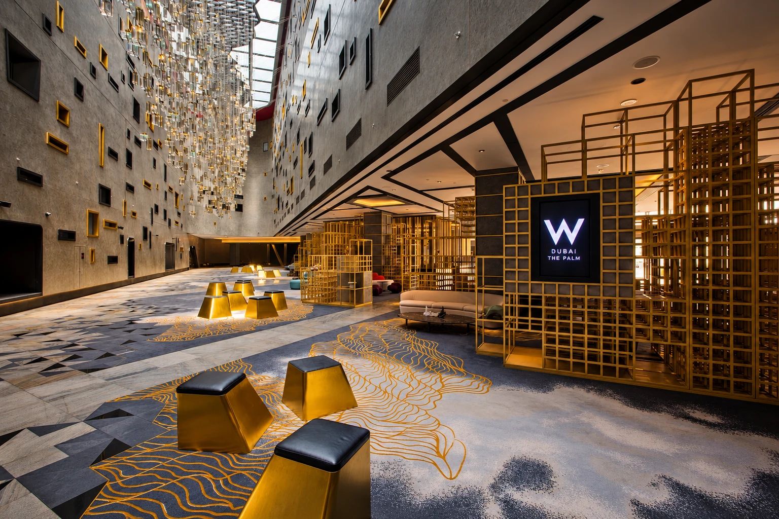 W Dubai - The Palm hotel lobby, gold lattice screens and geometric marble floor