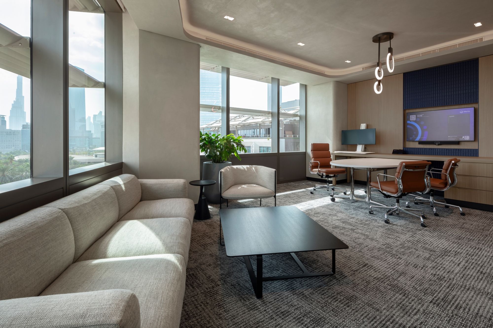 Executive flexi room at Informa Dubai designed by dwp, combining meeting and lounge spaces with natural light and views across Dubai.